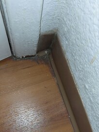 Floor with dirt caked in corner