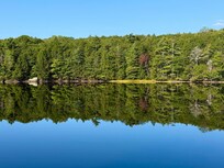 The lake would often be like a mirror, and the trees were just beginning to change.