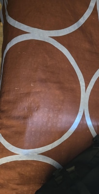 Stains on the bedspread and sheets.