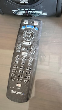 Dusty remote behind bed