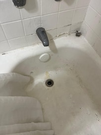 Broken tub stopper on side of tub. Broken knob.