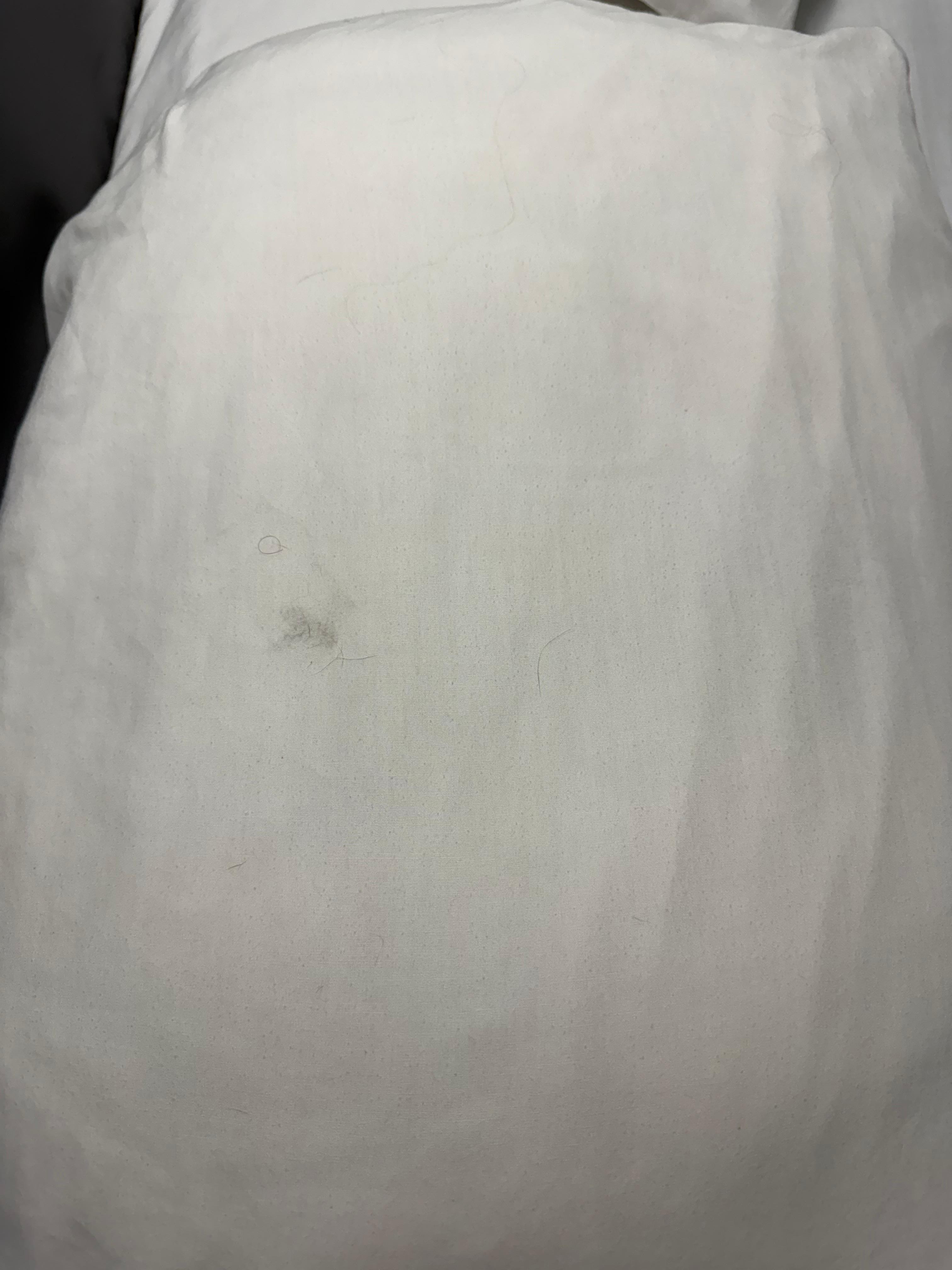 Pillowcase with stains and hair