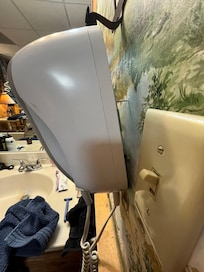 Blow dryer hanging by one screw