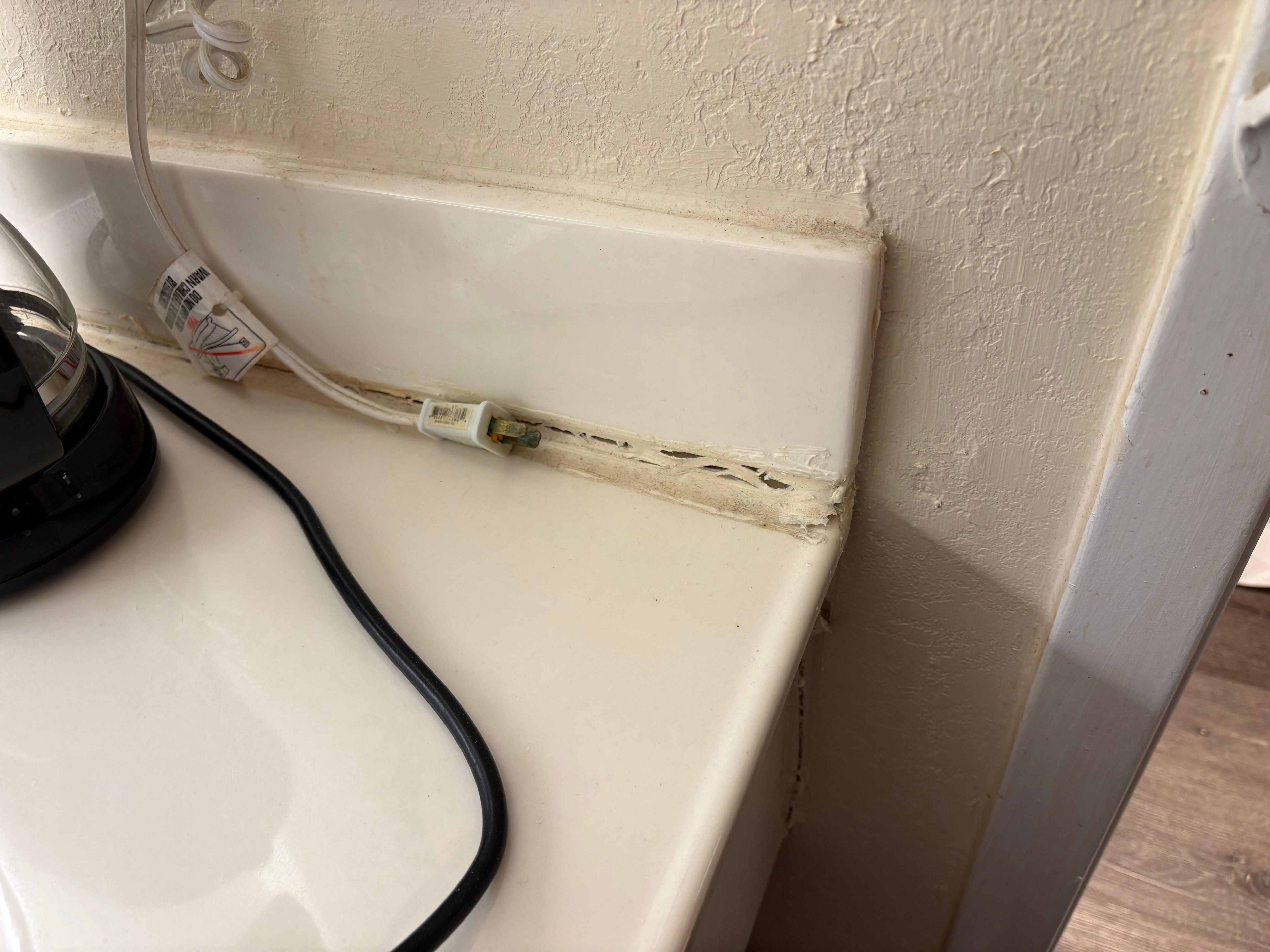 Sink countertop was sagging and there’s not enough caulk to hide it. 