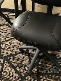 Shows worn leather chair