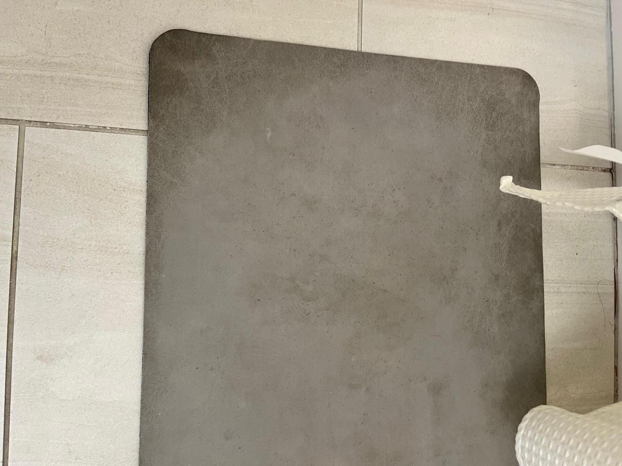 gray bathmat that is dirty