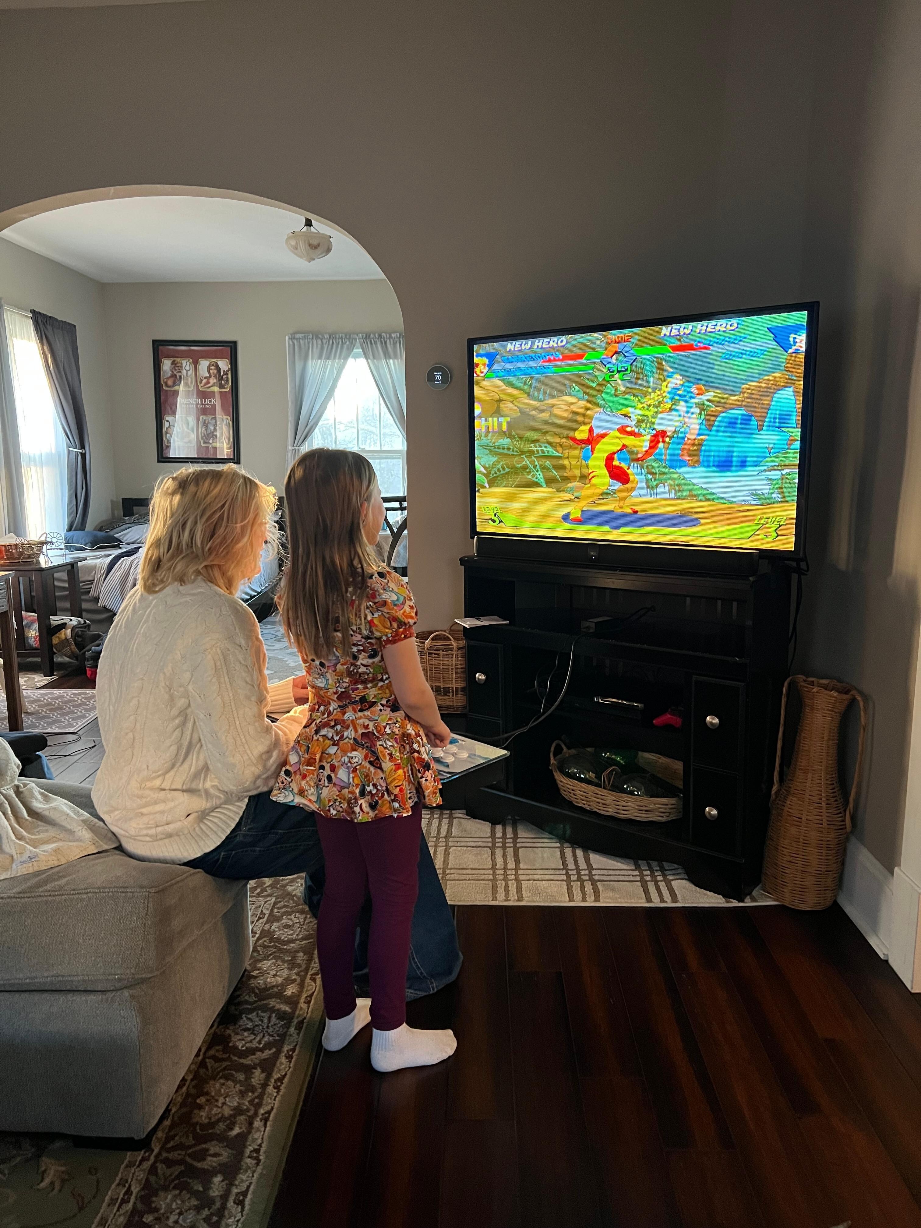The kids enjoyed the video game that was hooked up to the tv. 