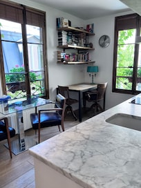 View of main area from bathroom door. Kitchen counter is seen.