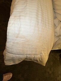 Dirty bedding that had not been changed from previous guest