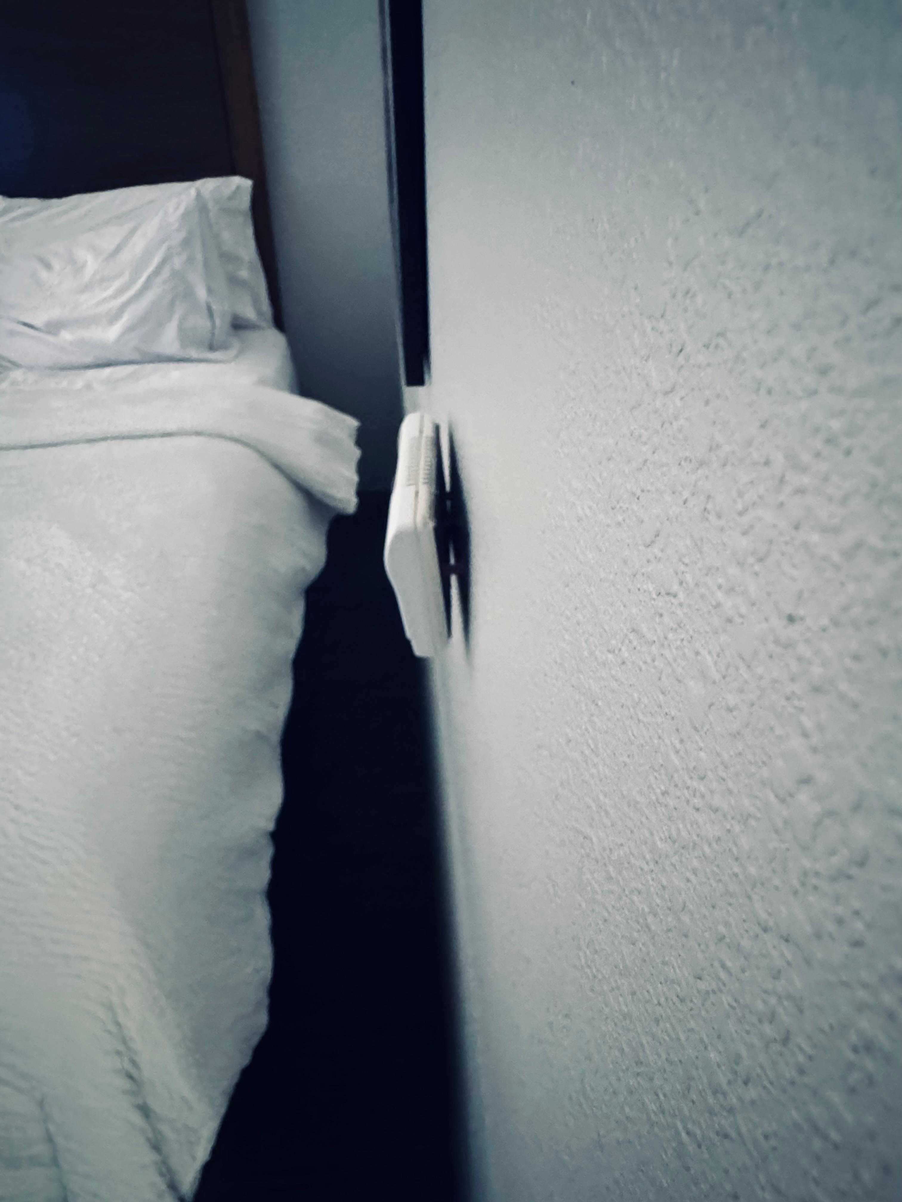 Loose thermostat on the wall.