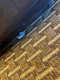 A piece of toilet paper or tissue laying next to the bed