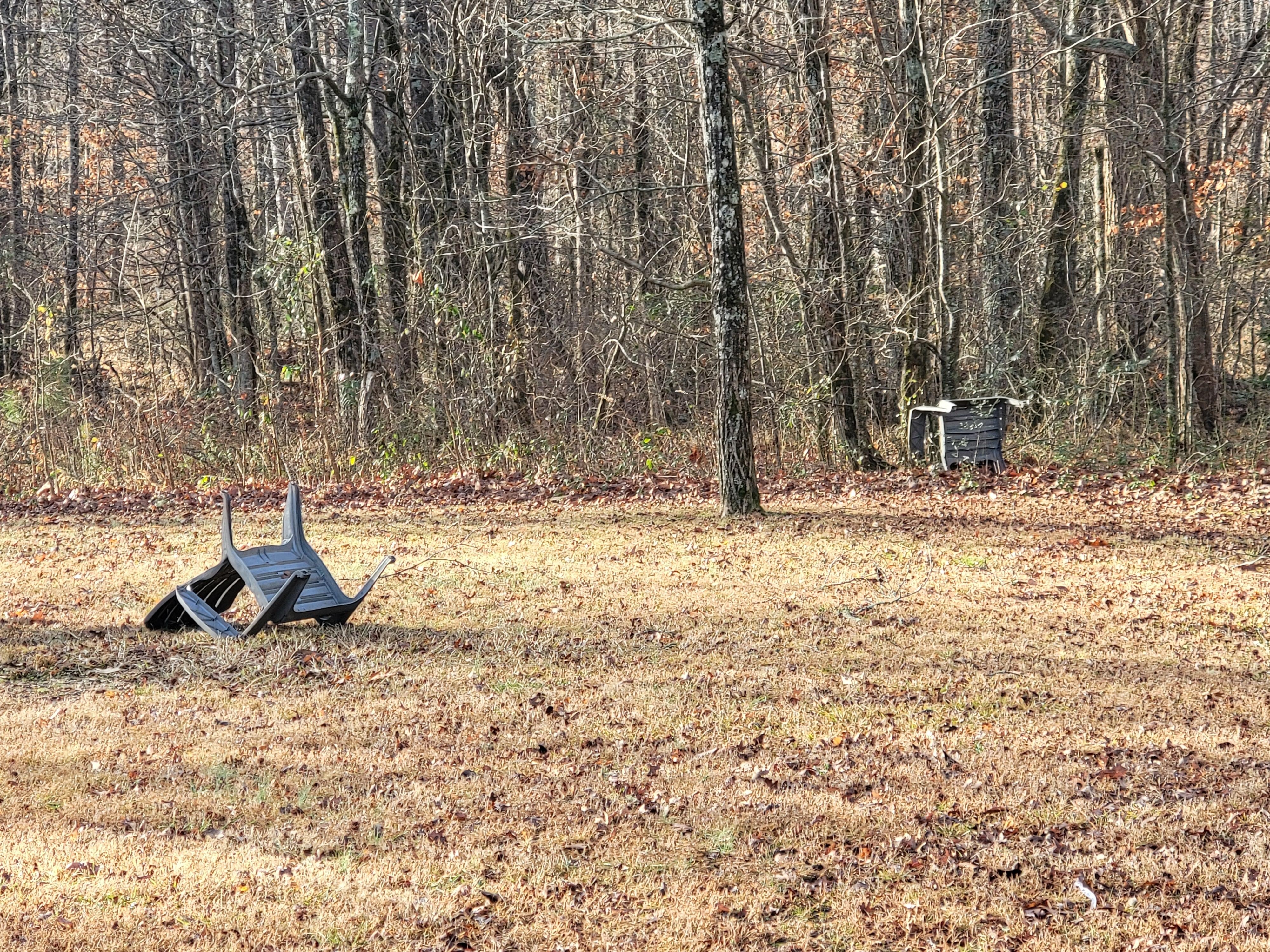 Chairs thrown in the woods and one broken 