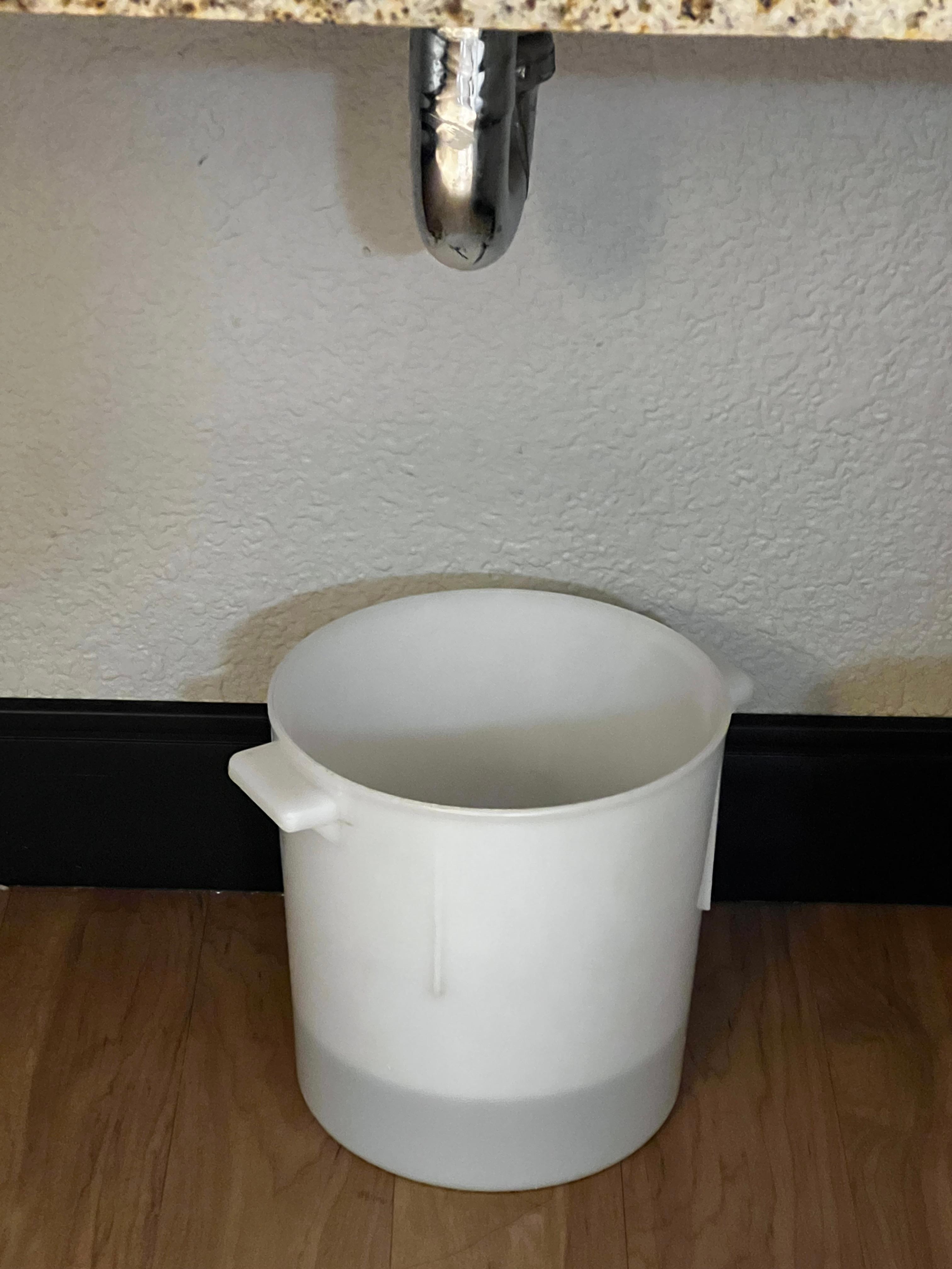 Bucket under sink to gather water from leak