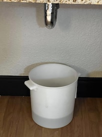 Bucket under sink to gather water from leak