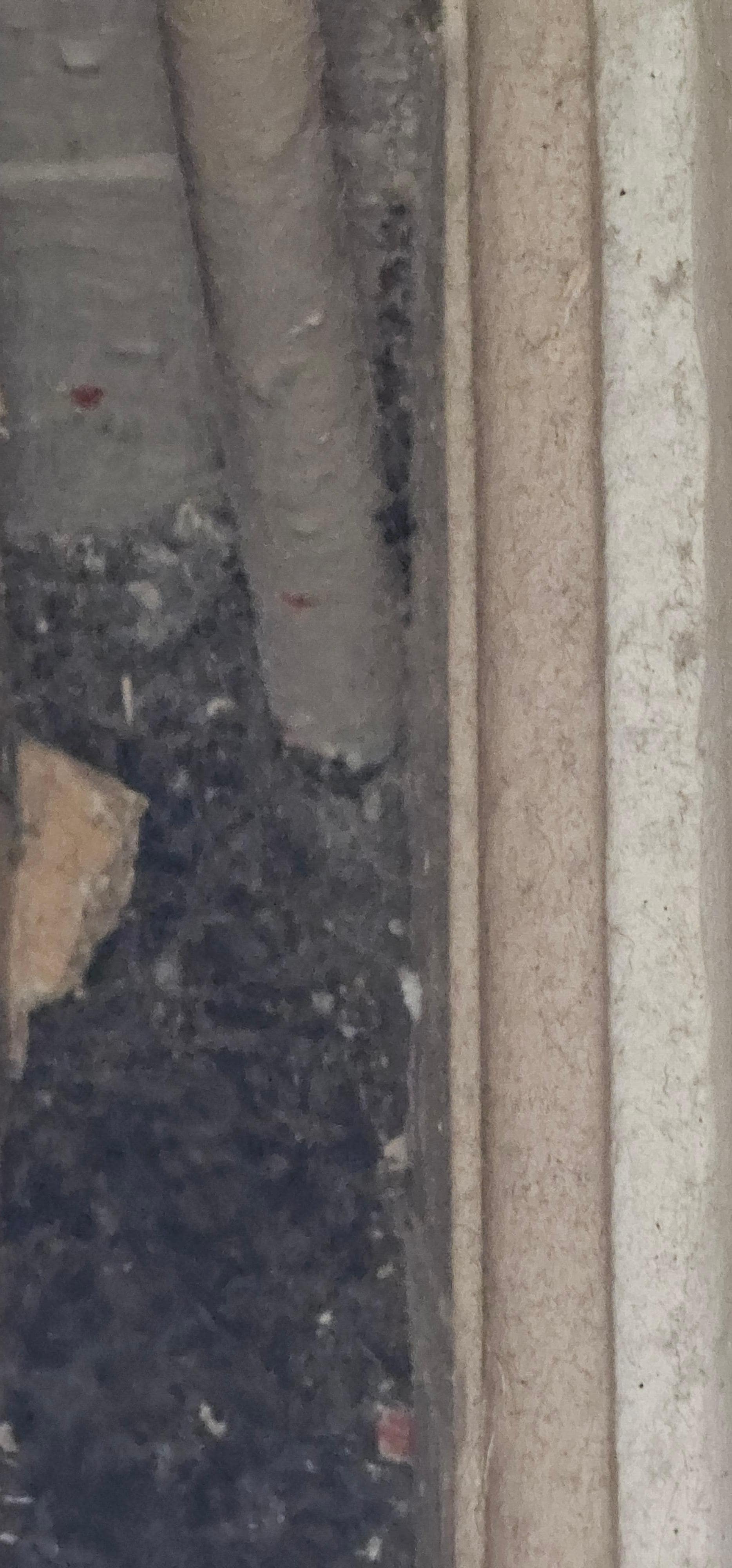 Filthy carpet and wall by the wardrobe.