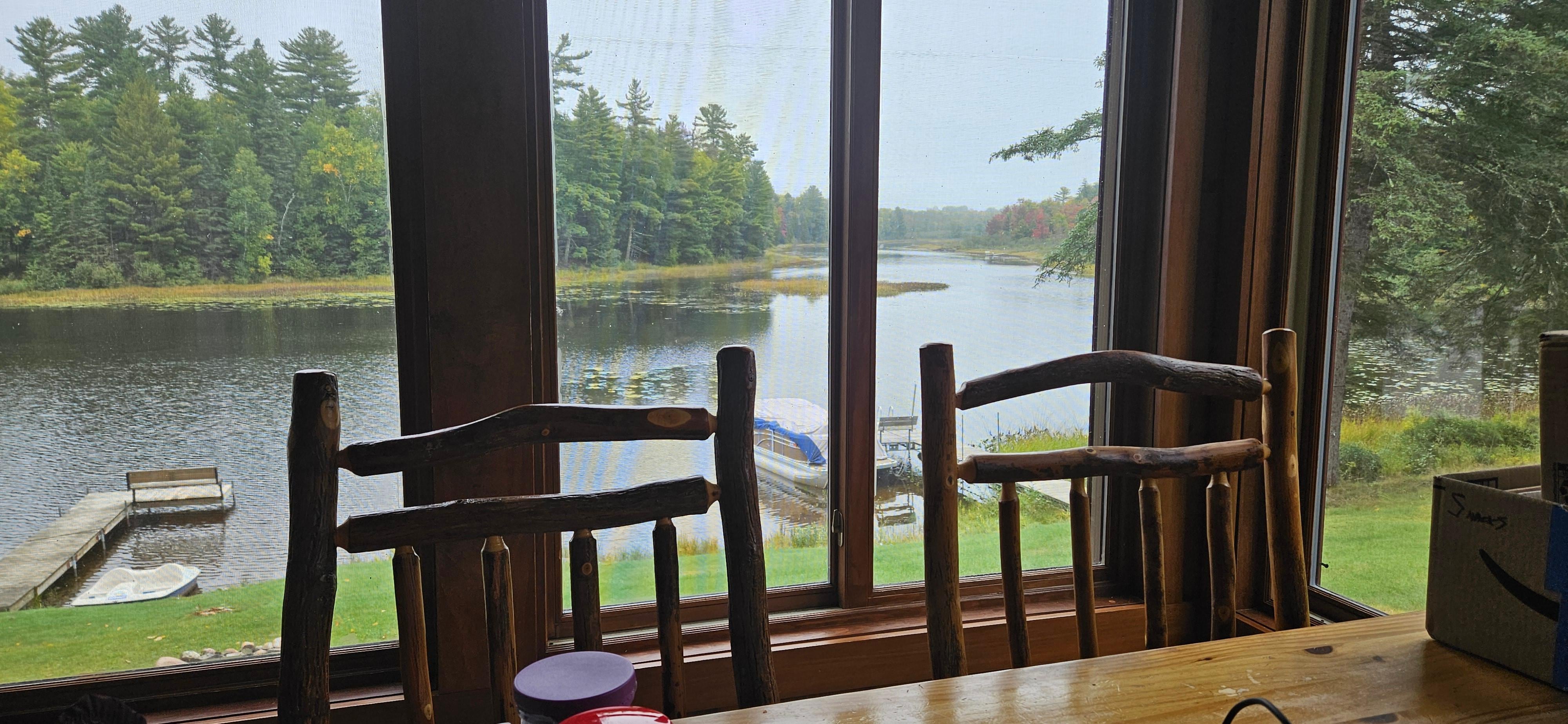 Lake view from the sunroom.  Large table for family meals and games.