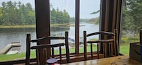 Lake view from the sunroom. Large table for family meals and games.