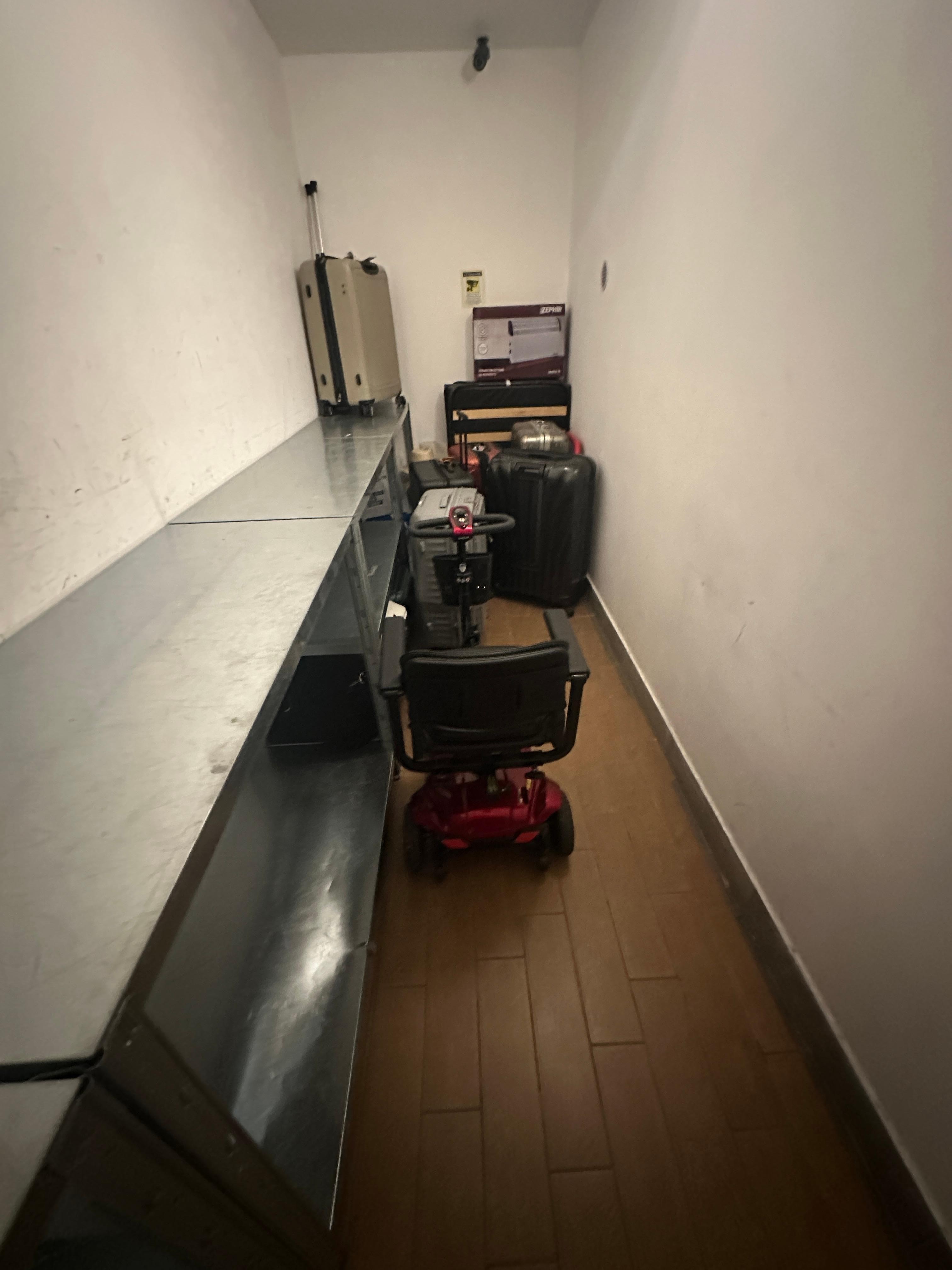 The locked storage closet for mobility, scooters, and luggage upon check .