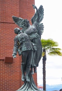 The Angel of Victory statute. It was sculpted by Coeur de Lion MacCarthy. The bronze statue depicts a female angel ascending to heaven with a fallen soldier. It is located outside Waterfront Station.