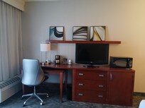 There is a small refrigerator in the cupboard