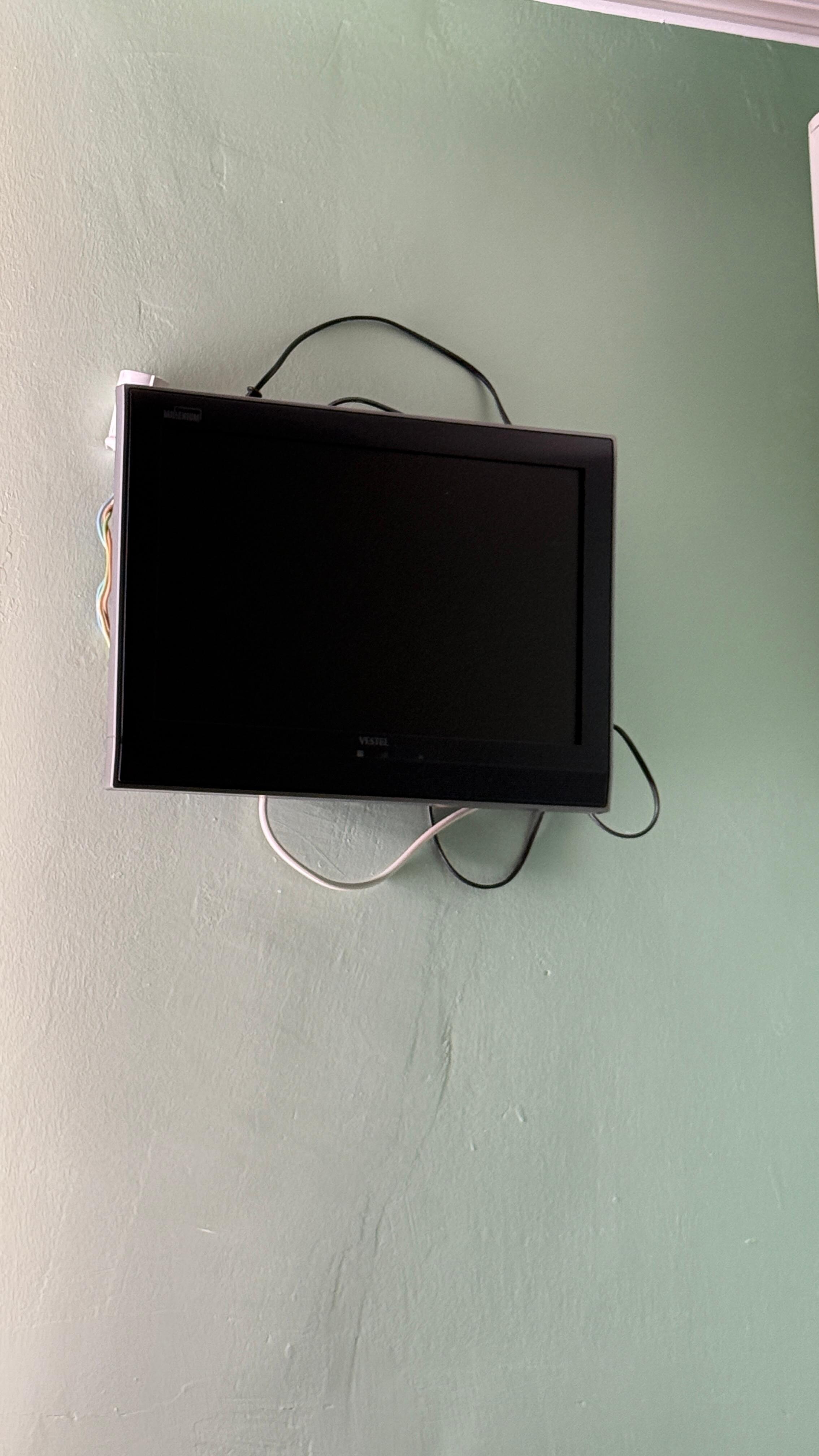TV hanging with cables all over