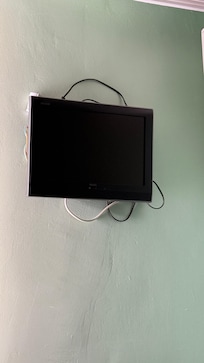 TV hanging with cables all over