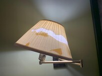 View of the wall mounted lamp in the room. Please install new lamps in the room.