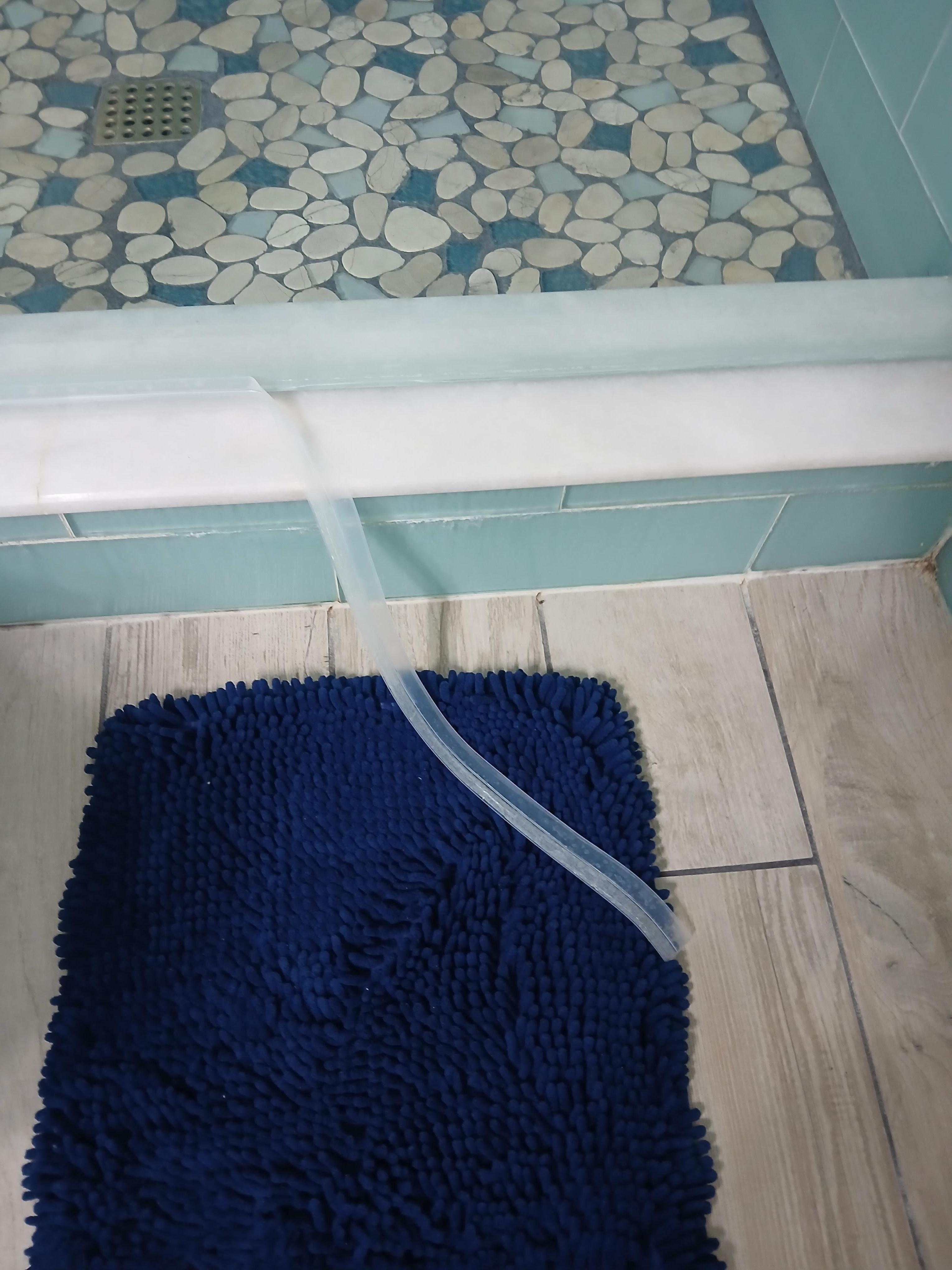 Tried to fix the stripping at the bottom of the shower door.  Water could literally be rung out of the bath mat.