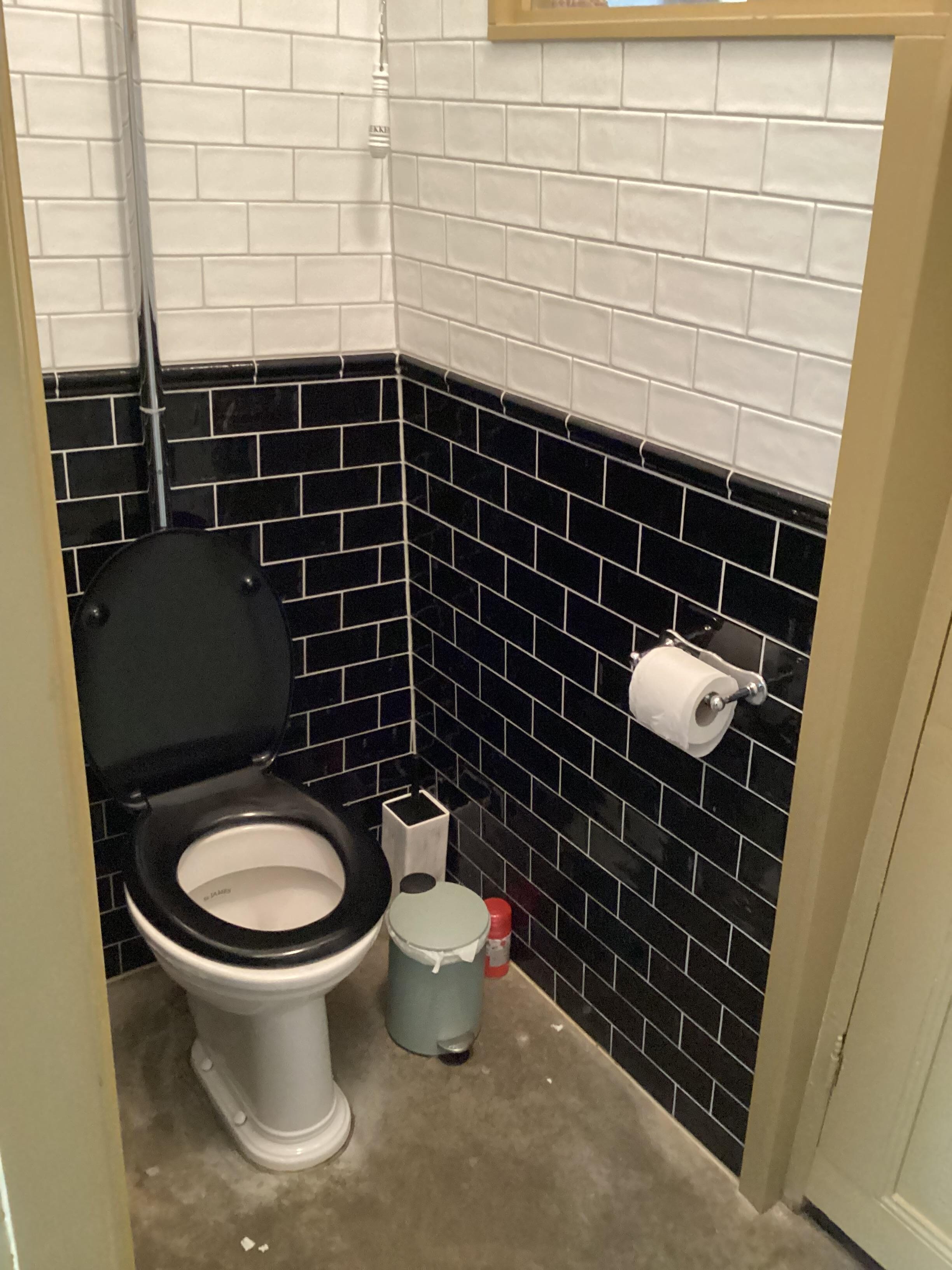 Toilet with no door, located next to the kitchen.