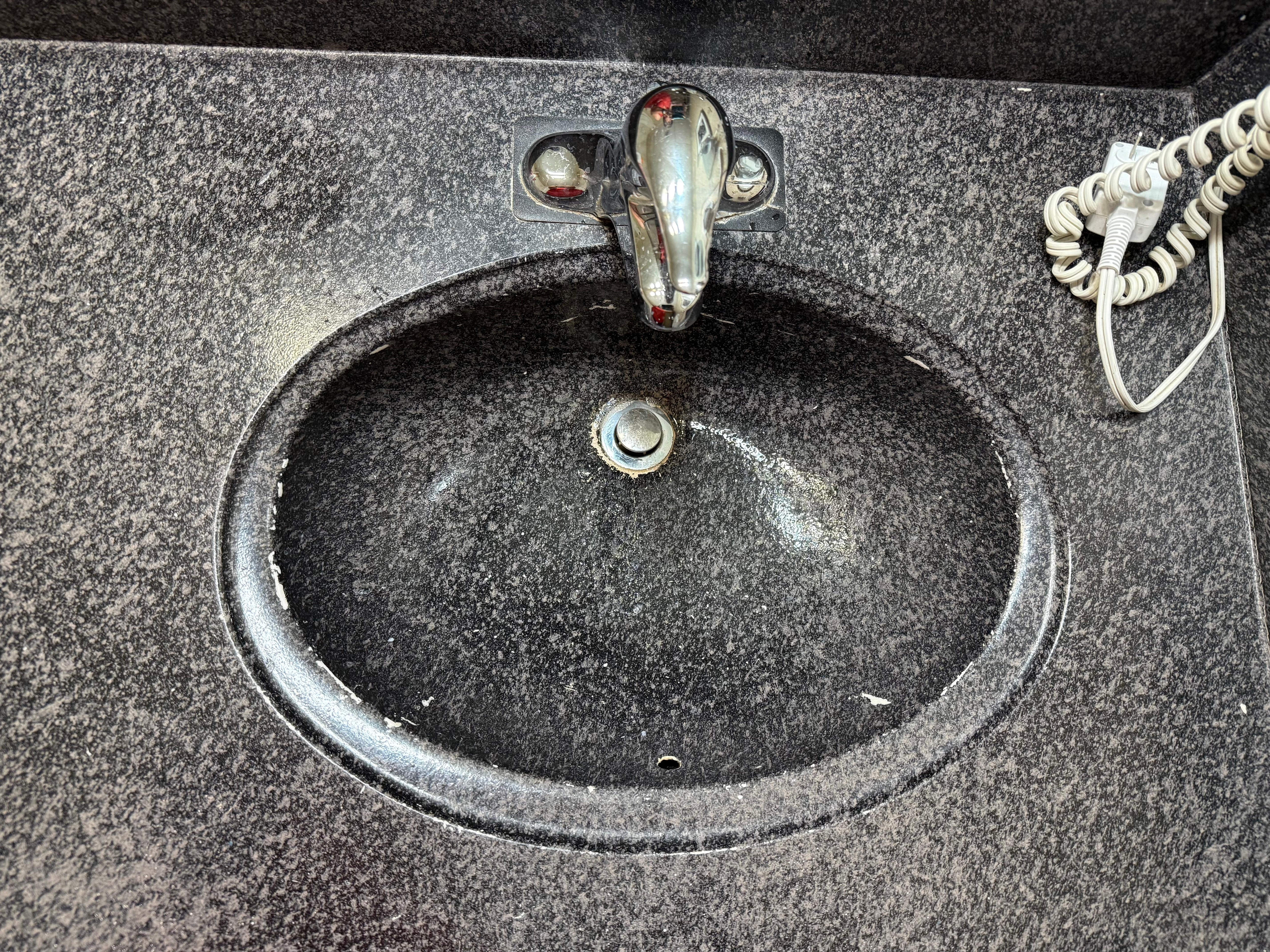 painted sink with the paint peeling