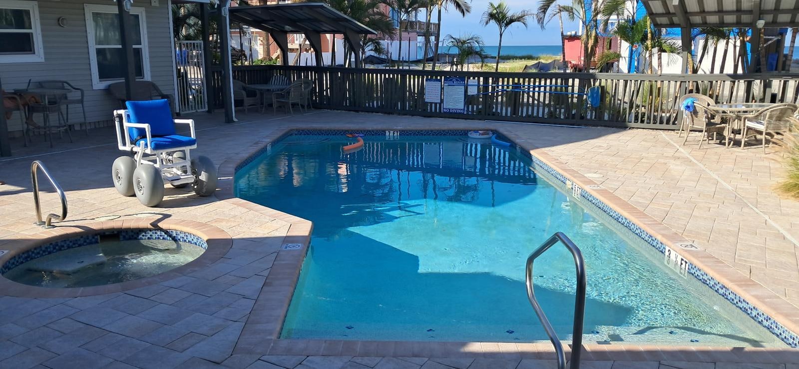 Nice big pool area with BBQ grills, tables and chairs