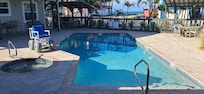 Nice big pool area with BBQ grills, tables and chairs