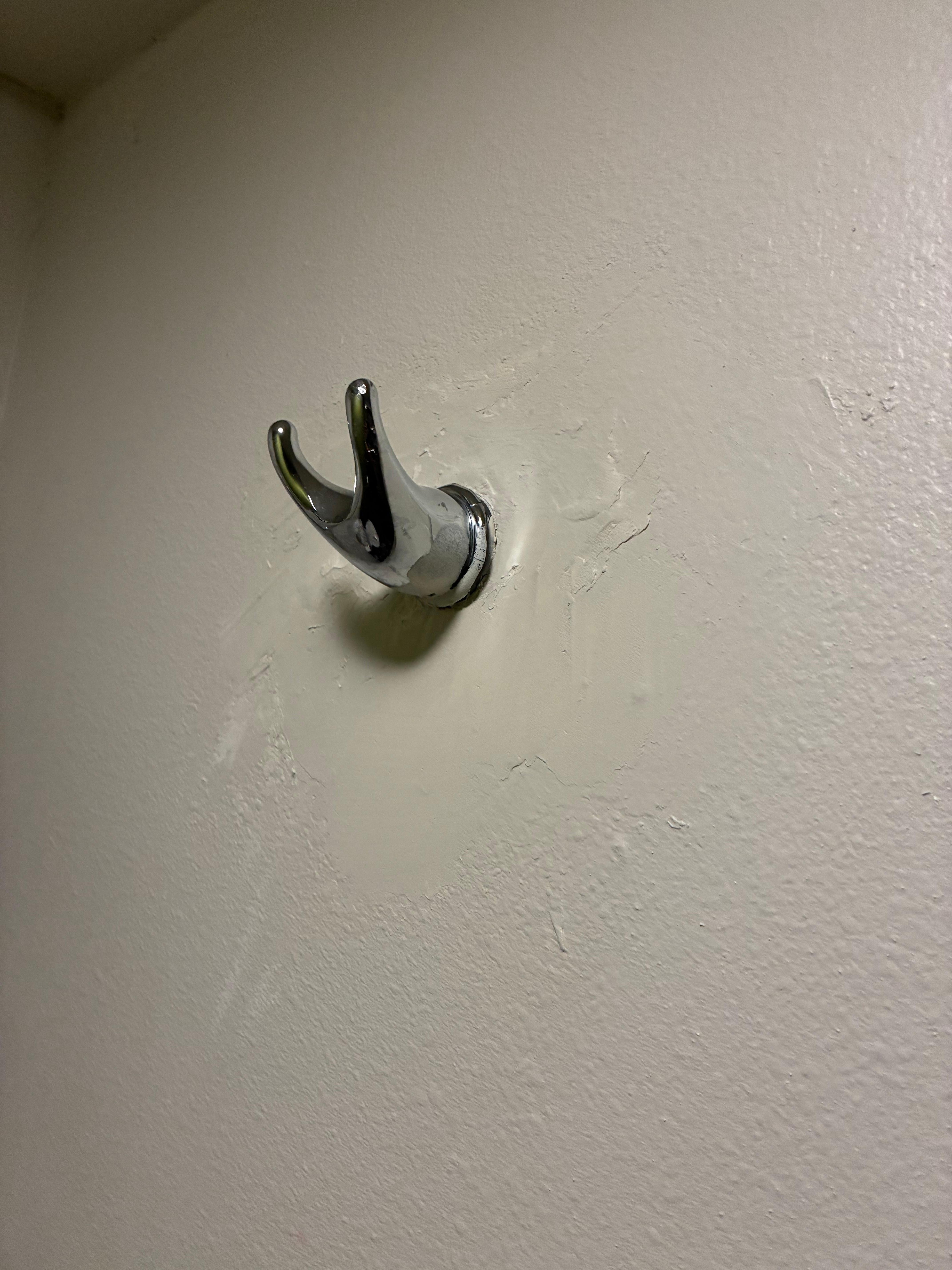 Patched up towel holder in bathroom