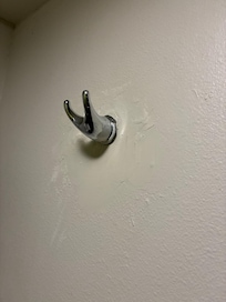 Patched up towel holder in bathroom