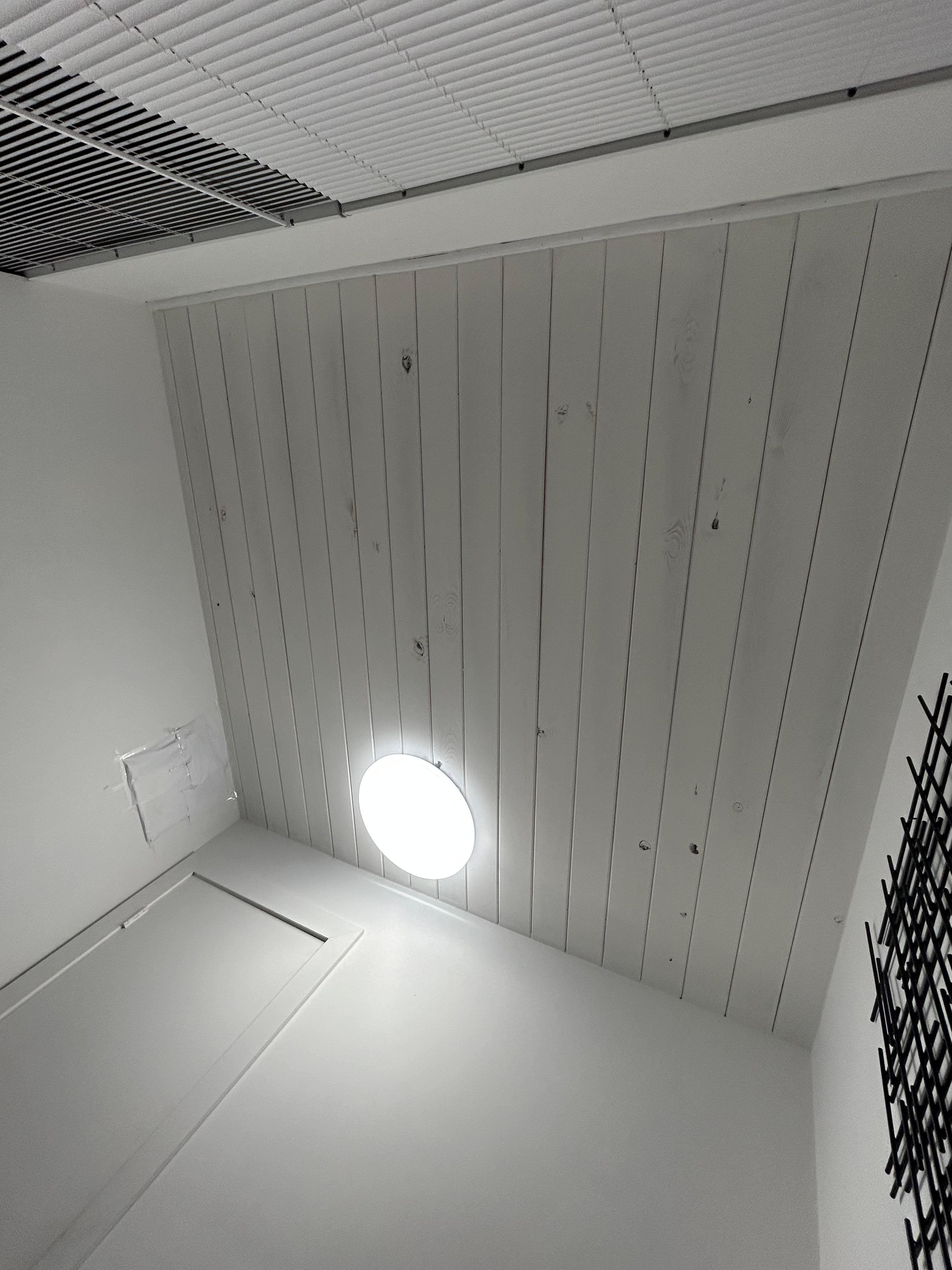 Holes in the ceiling and wall, wall hole covered by printer paper 