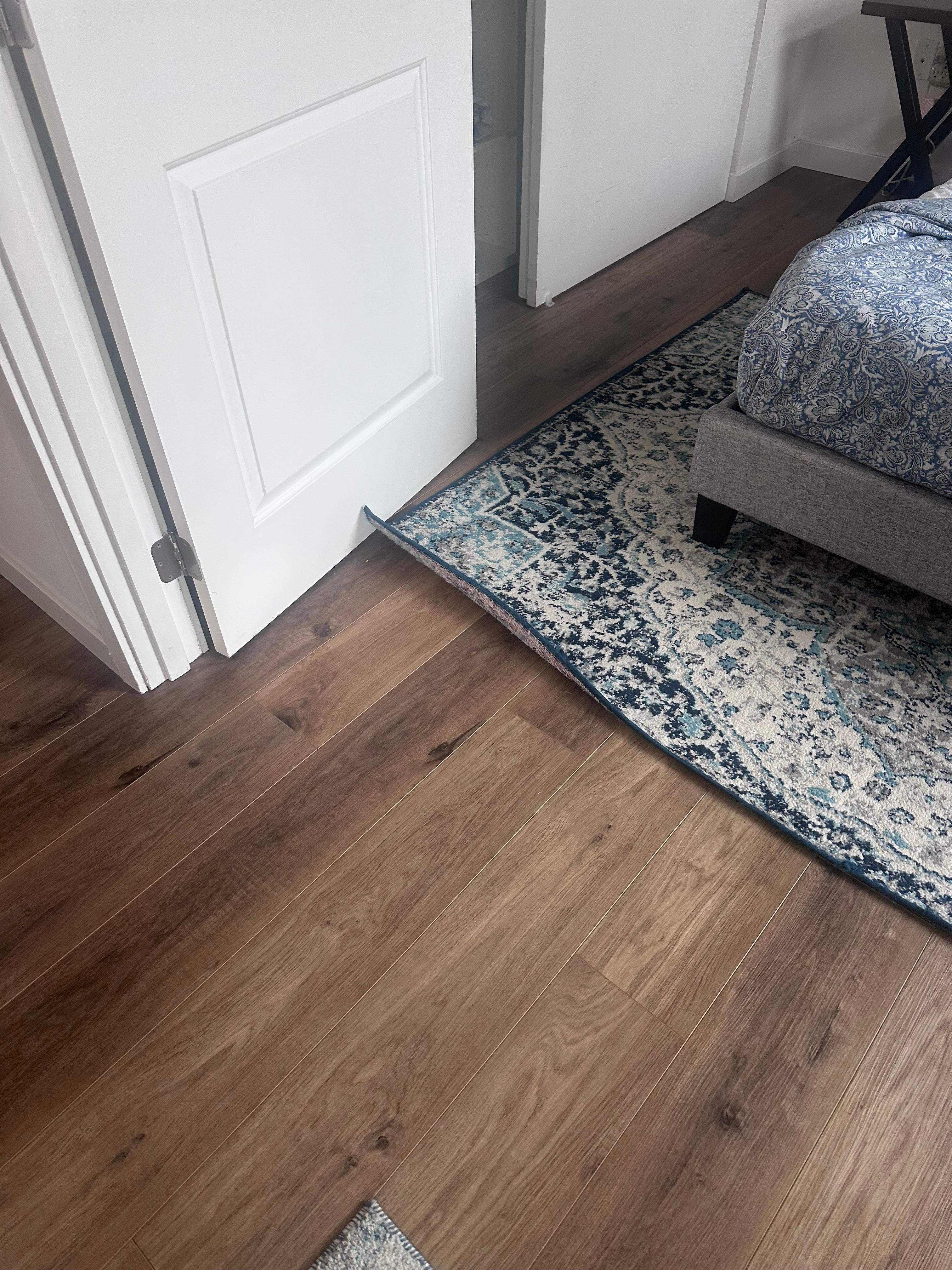 The rug was curled here, this door could close but not the other door 