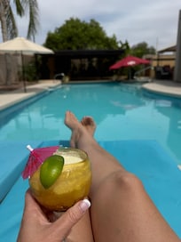Sitting by the pool with a soda and fruit.
