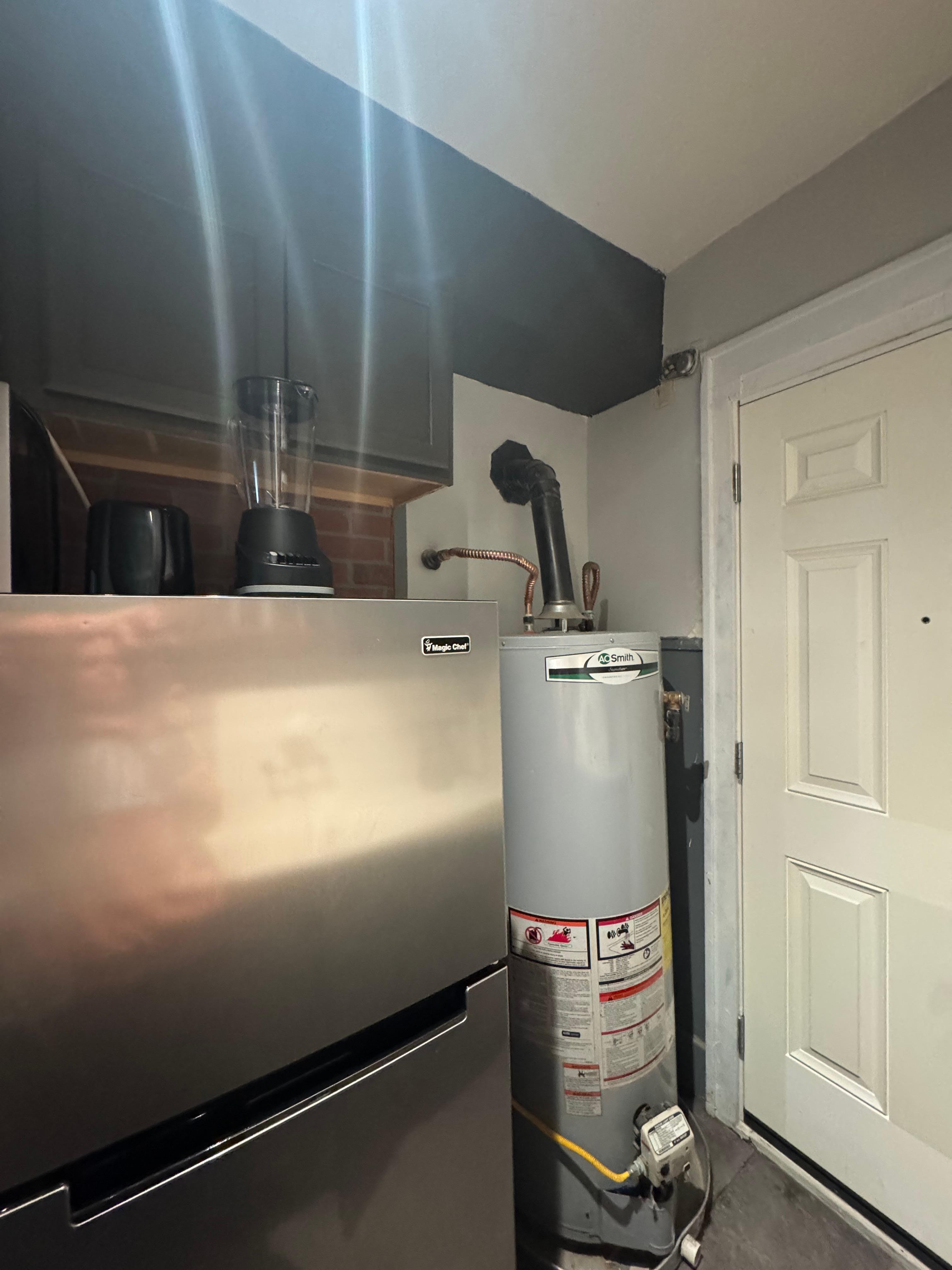 Gas water heater in same room as gas stove; another exterior door also shown