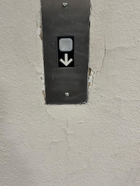 Plaster peeling and holes starting around elevator button