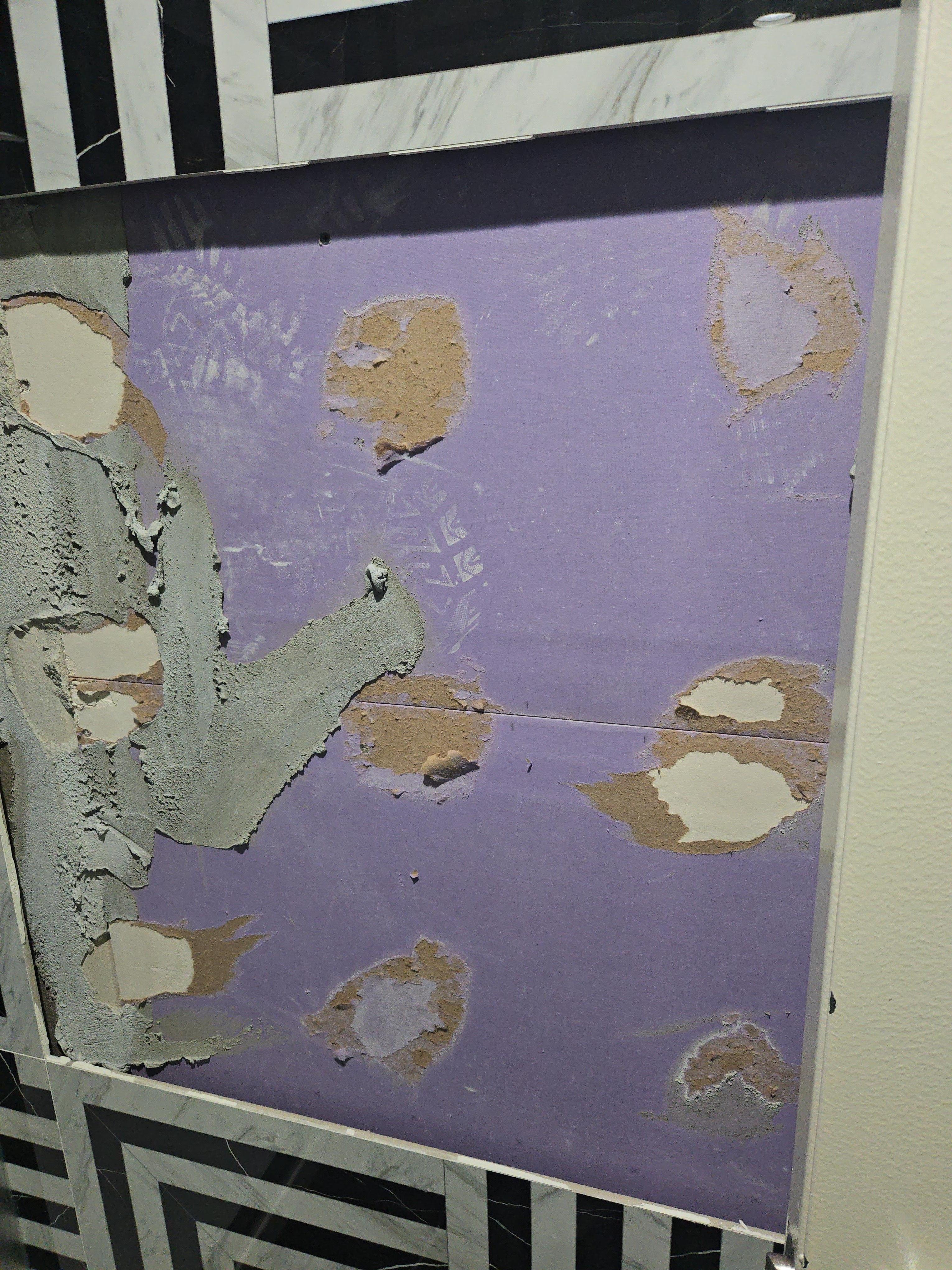 Missing tile in the bathroom. Directly in front of the toilet.