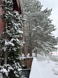 Side of building with snow - facing resort at the end of the road