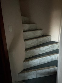 Interior stairs in a two-bedroom suite. No handrails and too narrow for a foot - dangerous for adults and children alike.