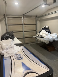Piled up sheets and towels with broken air hockey table