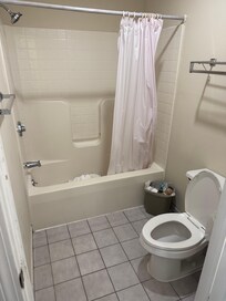 Tub fixture has big gap and there is weak shower pressure. Stains on bathroom wall