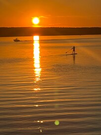 Enjoying the sunset from a paddle board.