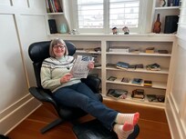 Perusing the books available in this cozy nook .