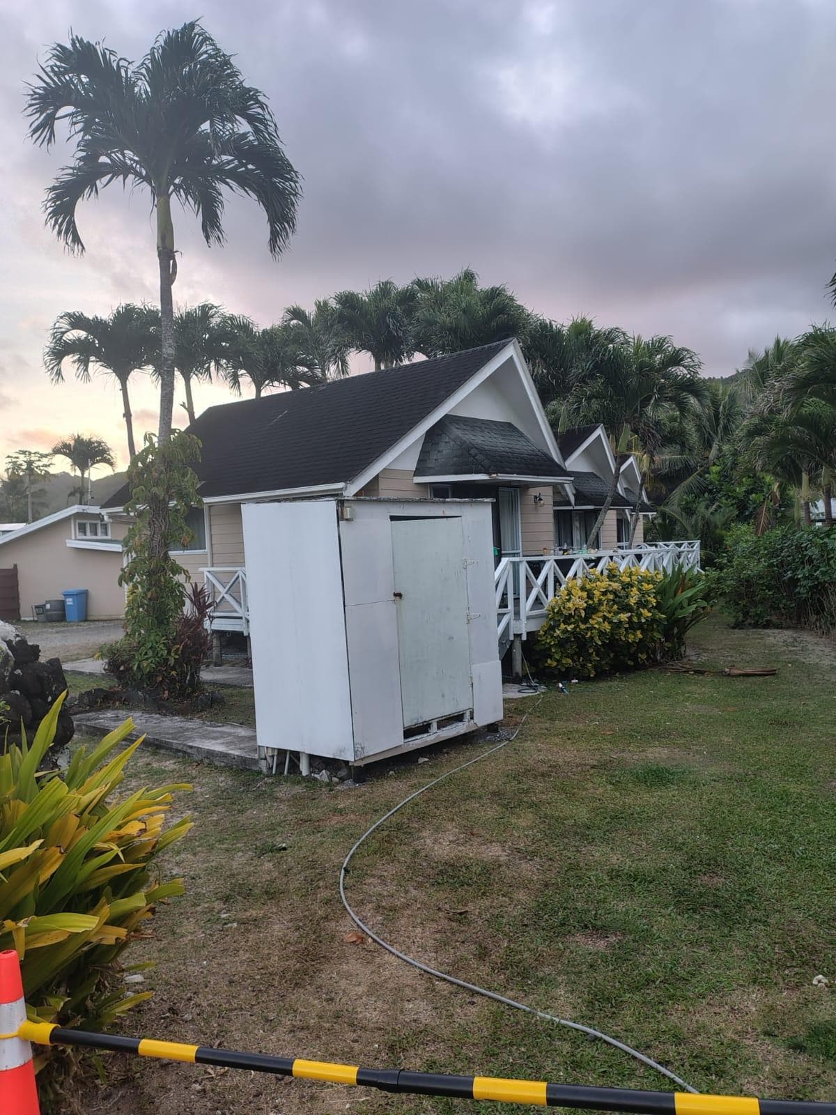 Close up of stinky shed with units in background