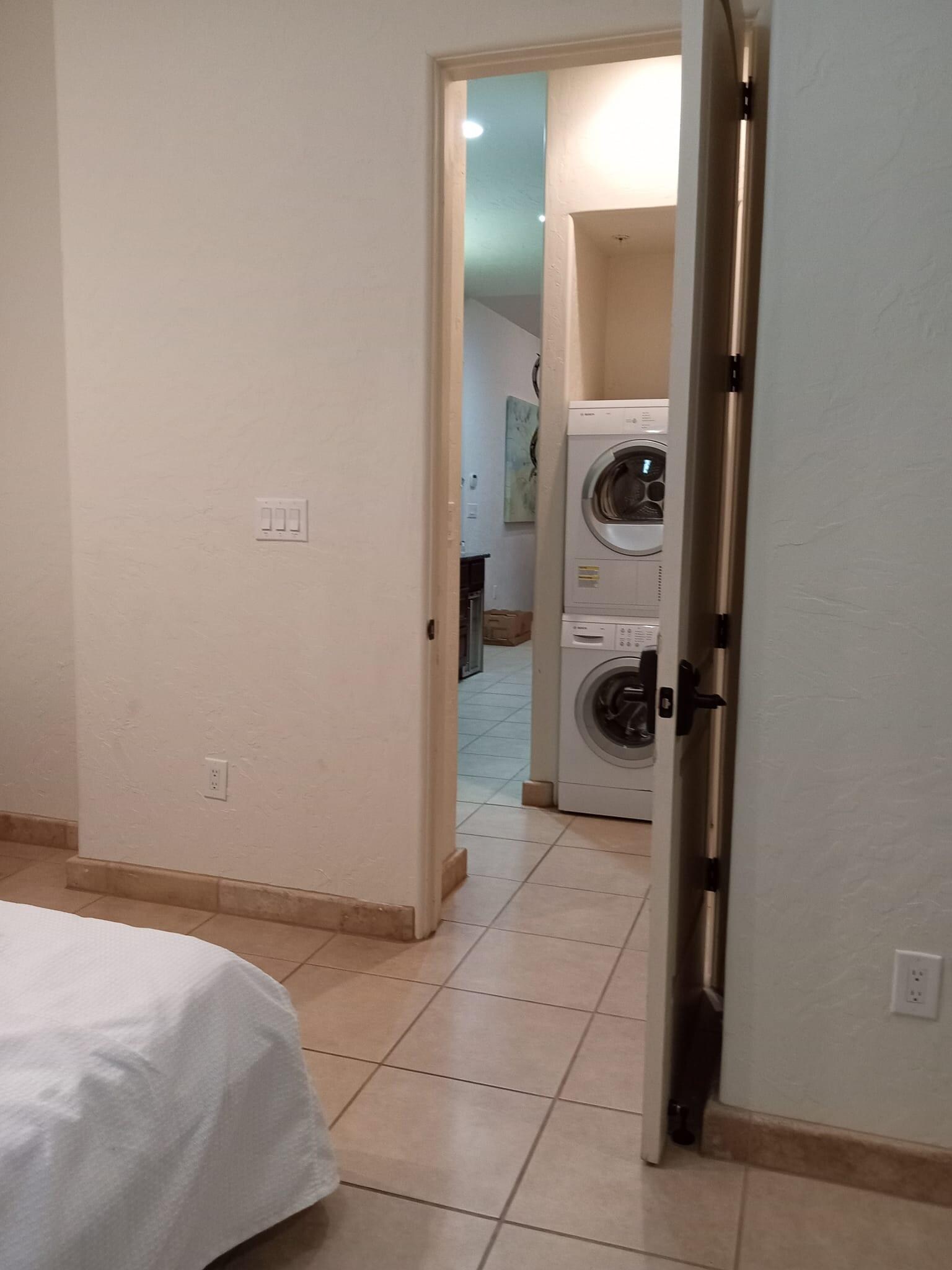 Master bedroom leading to kitchen, washer and dryer provided