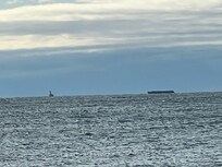 Tugboat pulling a Flatbed