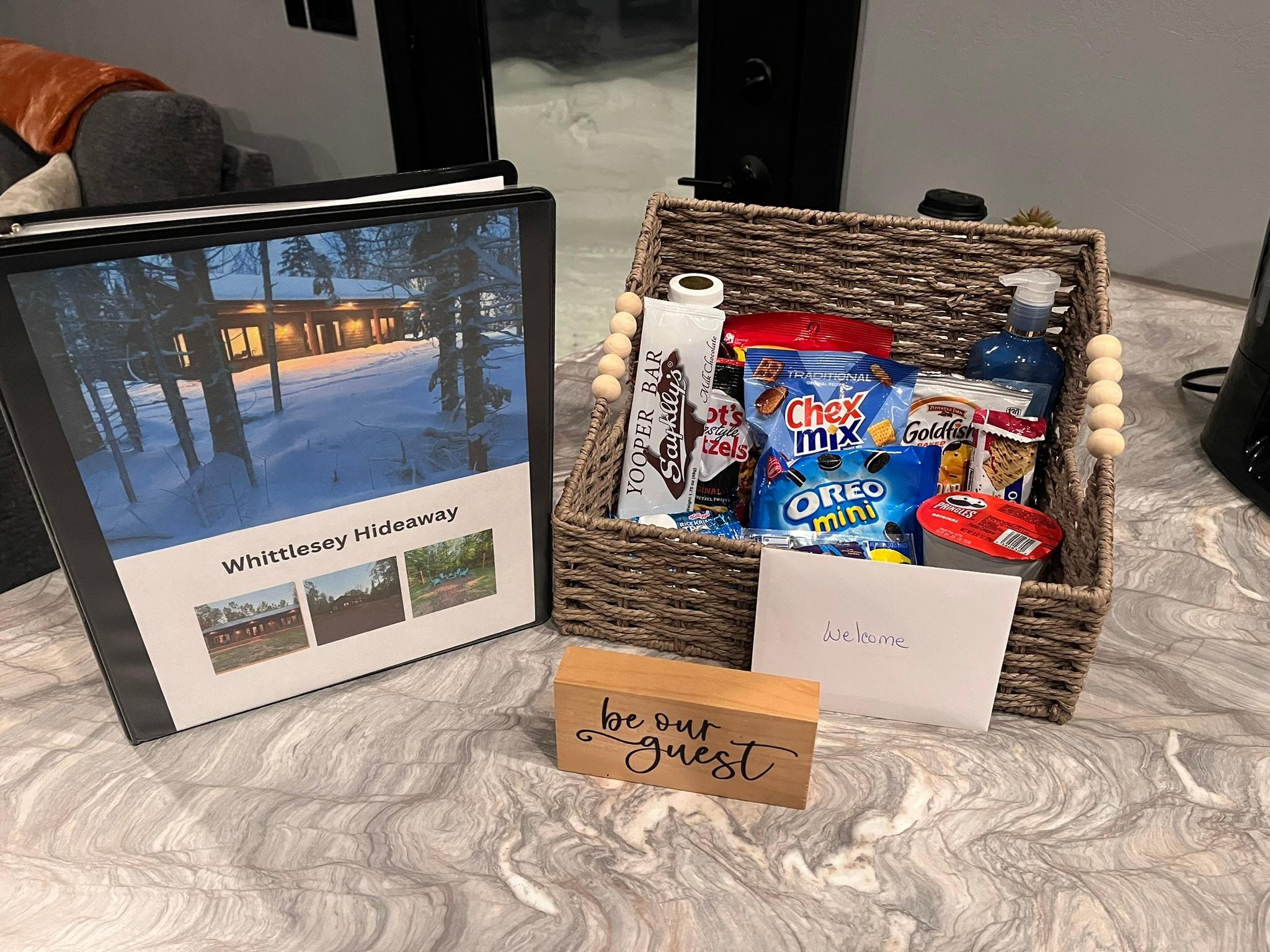 Welcome book, note, and basket of treats.
